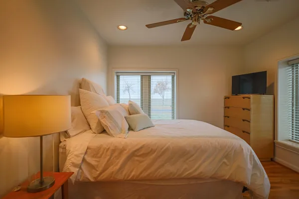 a bedroom with a bed and wooden floor