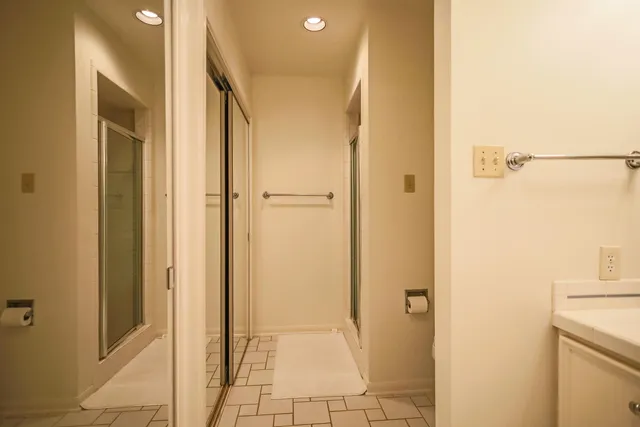 a bedroom with a bed and a view of living room
