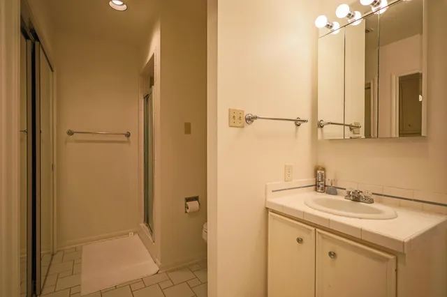 a bedroom with two beds and a chandelier