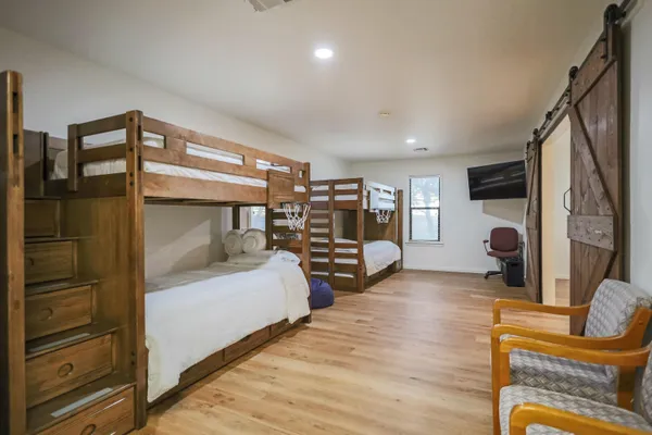 a bedroom with a bed and a chandelier
