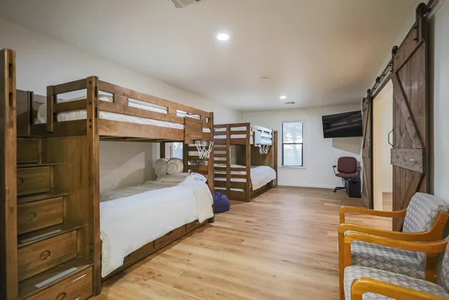 a bedroom with a bed and a chandelier