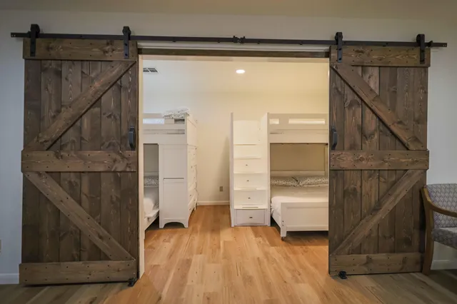 a bathroom with a toilet sink vanity and mirror