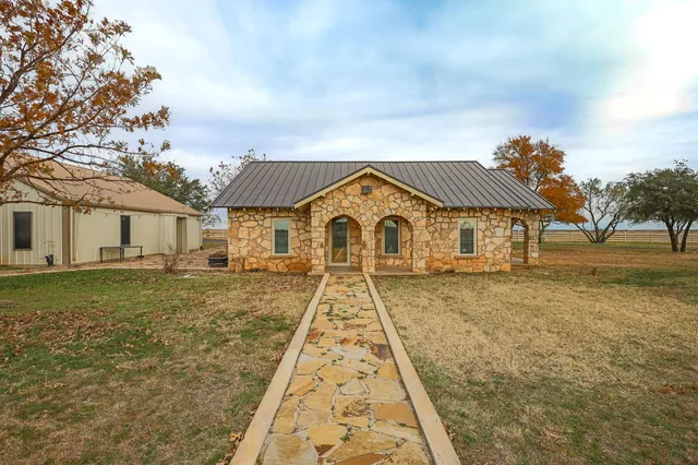a front view of a house with a yard