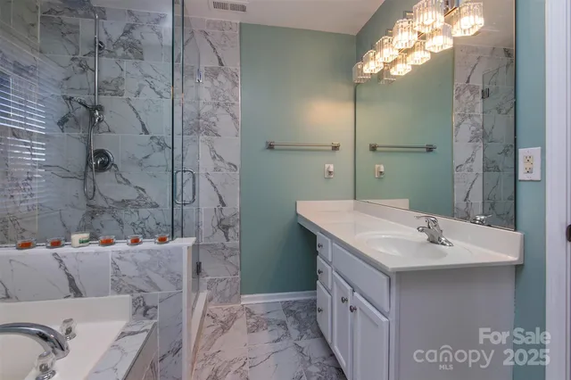 a bathroom with a sink vanity granite and a mirror