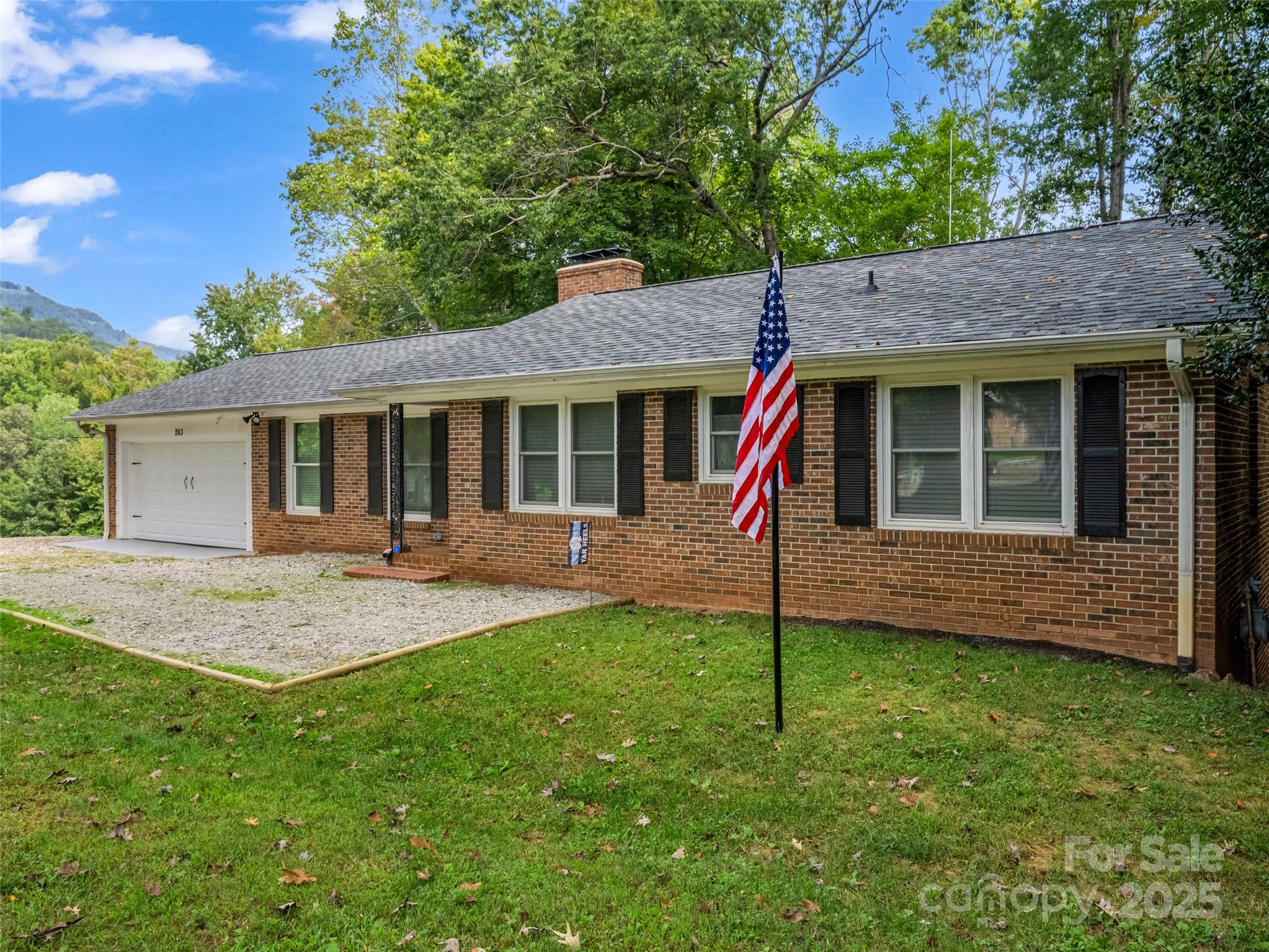 263 Blanton Street Columbus, NC 28722 - Photo 3 of 45 a view of a house with a yard and tree