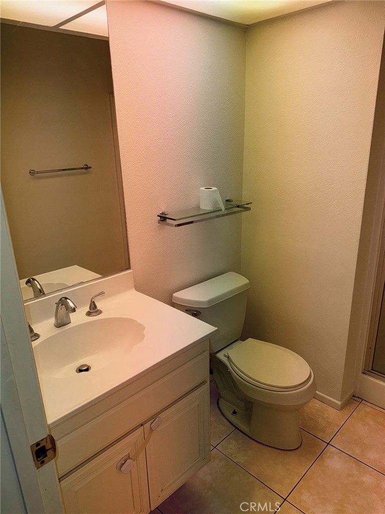 18419 Collins Street, Unit E Tarzana, CA 91356 - Photo 15 of 40 a bathroom with a sink and a toilet