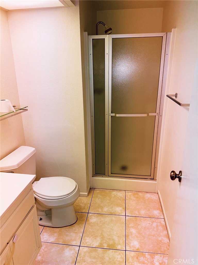 18419 Collins Street, Unit E Tarzana, CA 91356 - Photo 16 of 40 a bathroom with a toilet and a shower