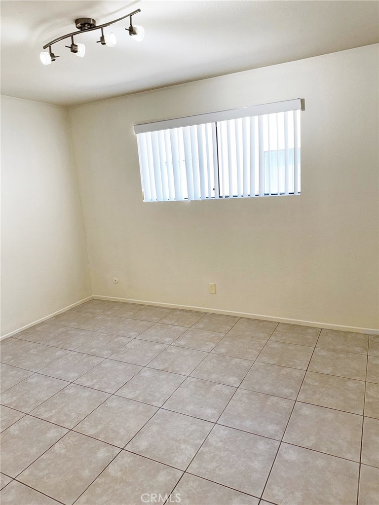 18419 Collins Street, Unit E Tarzana, CA 91356 - Photo 17 of 40 an empty room with windows