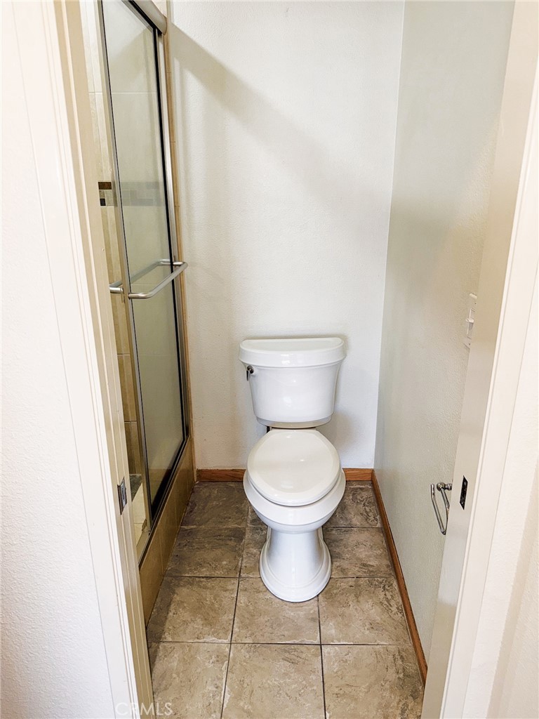 18419 Collins Street, Unit E Tarzana, CA 91356 - Photo 20 of 40 a bathroom with a toilet and a shower