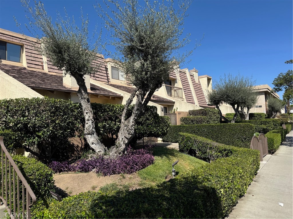 18419 Collins Street, Unit E Tarzana, CA 91356 - Photo 2 of 40 a front view of a house with a yard