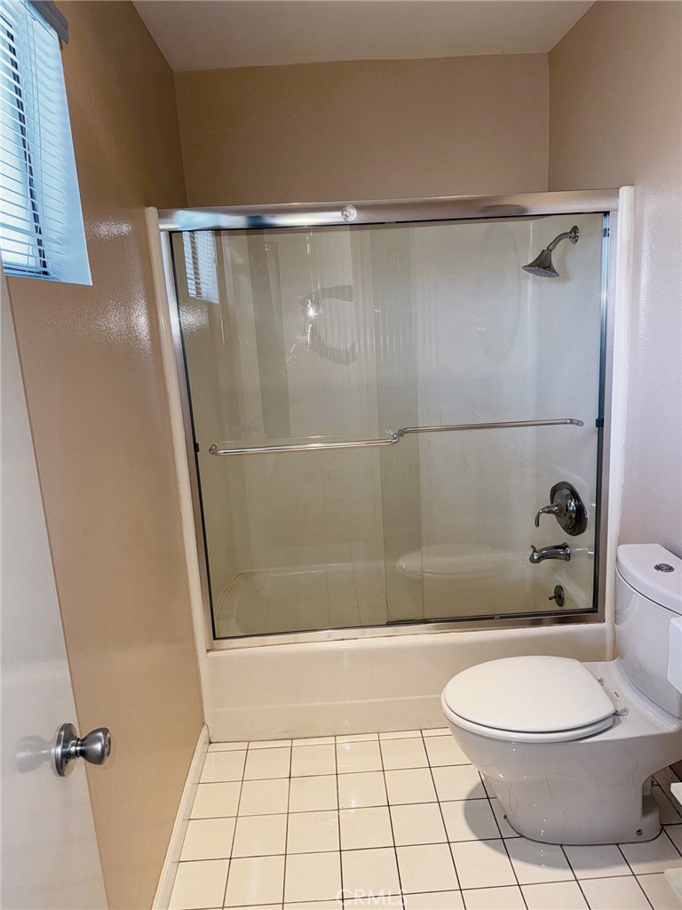18419 Collins Street, Unit E Tarzana, CA 91356 - Photo 24 of 40 a bathroom with a toilet and a shower