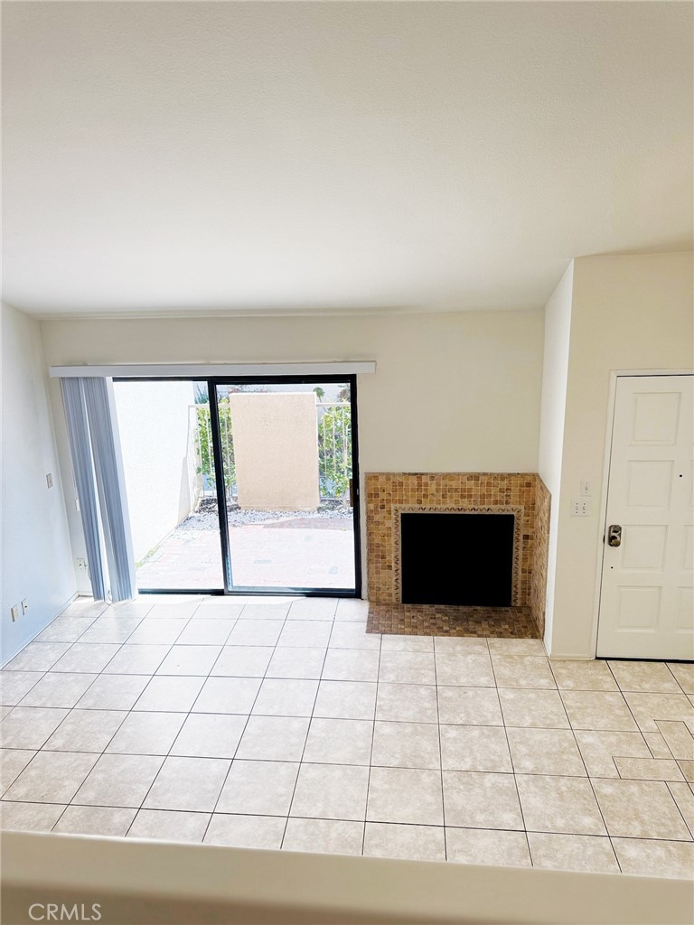 18419 Collins Street, Unit E Tarzana, CA 91356 - Photo 4 of 40 a view of an empty room with a fireplace and a window