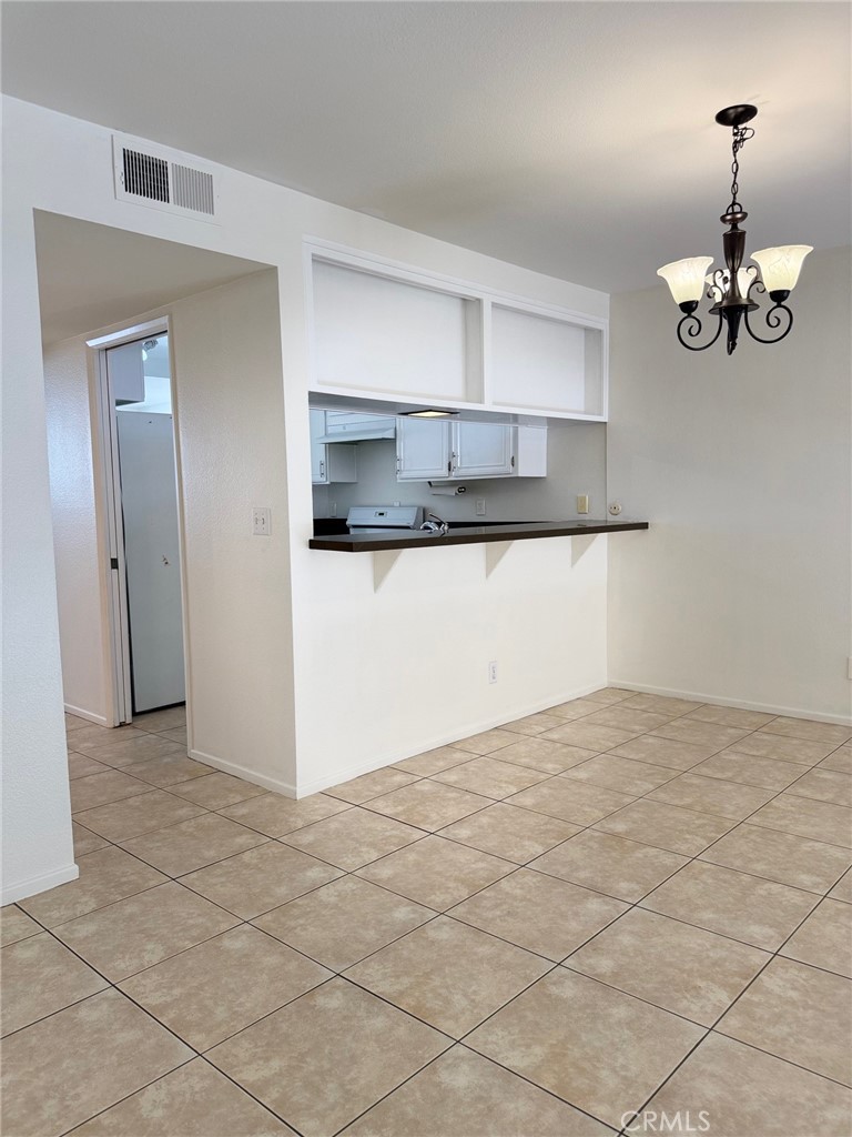 18419 Collins Street, Unit E Tarzana, CA 91356 - Photo 8 of 40 a kitchen with granite countertop a stove a sink and a refrigerator