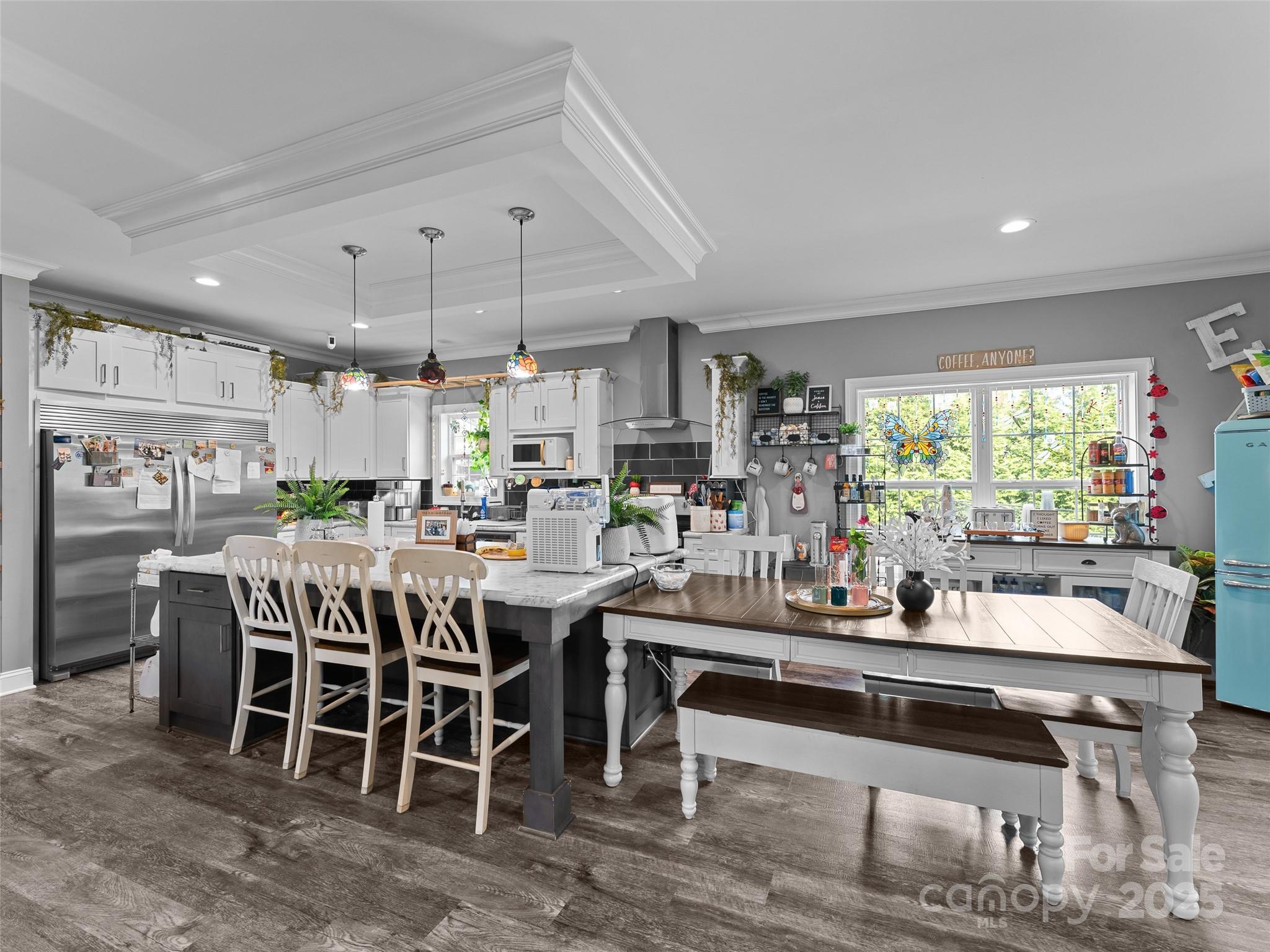 1154 North Ridge Road Hendersonville, NC 28792 - Photo 16 of 29 a dining hall with stainless steel appliances granite countertop a table chairs stove a refrigerator and chandelier