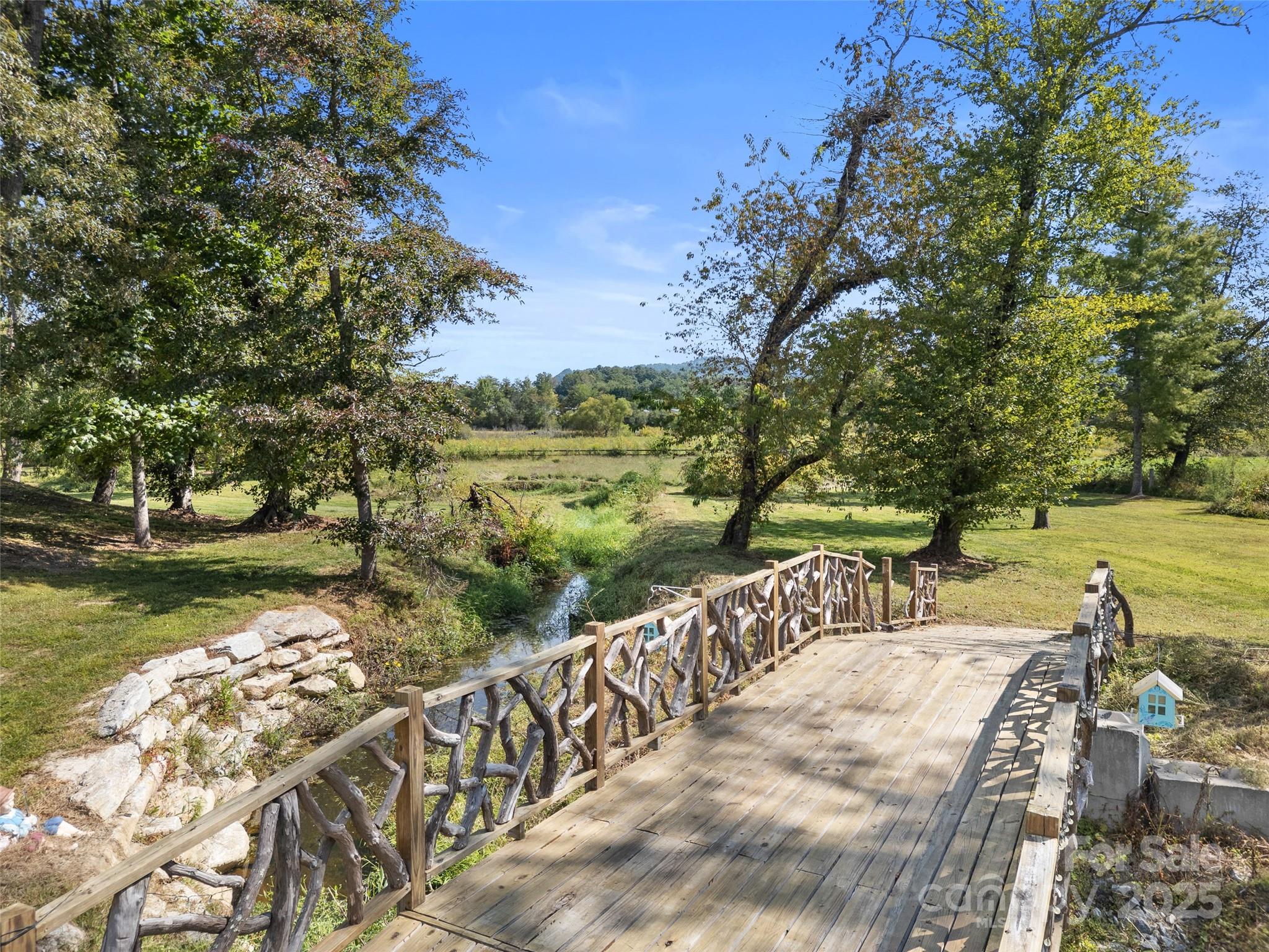 1154 North Ridge Road Hendersonville, NC 28792 - Photo 8 of 29 a view of a lake with a garden