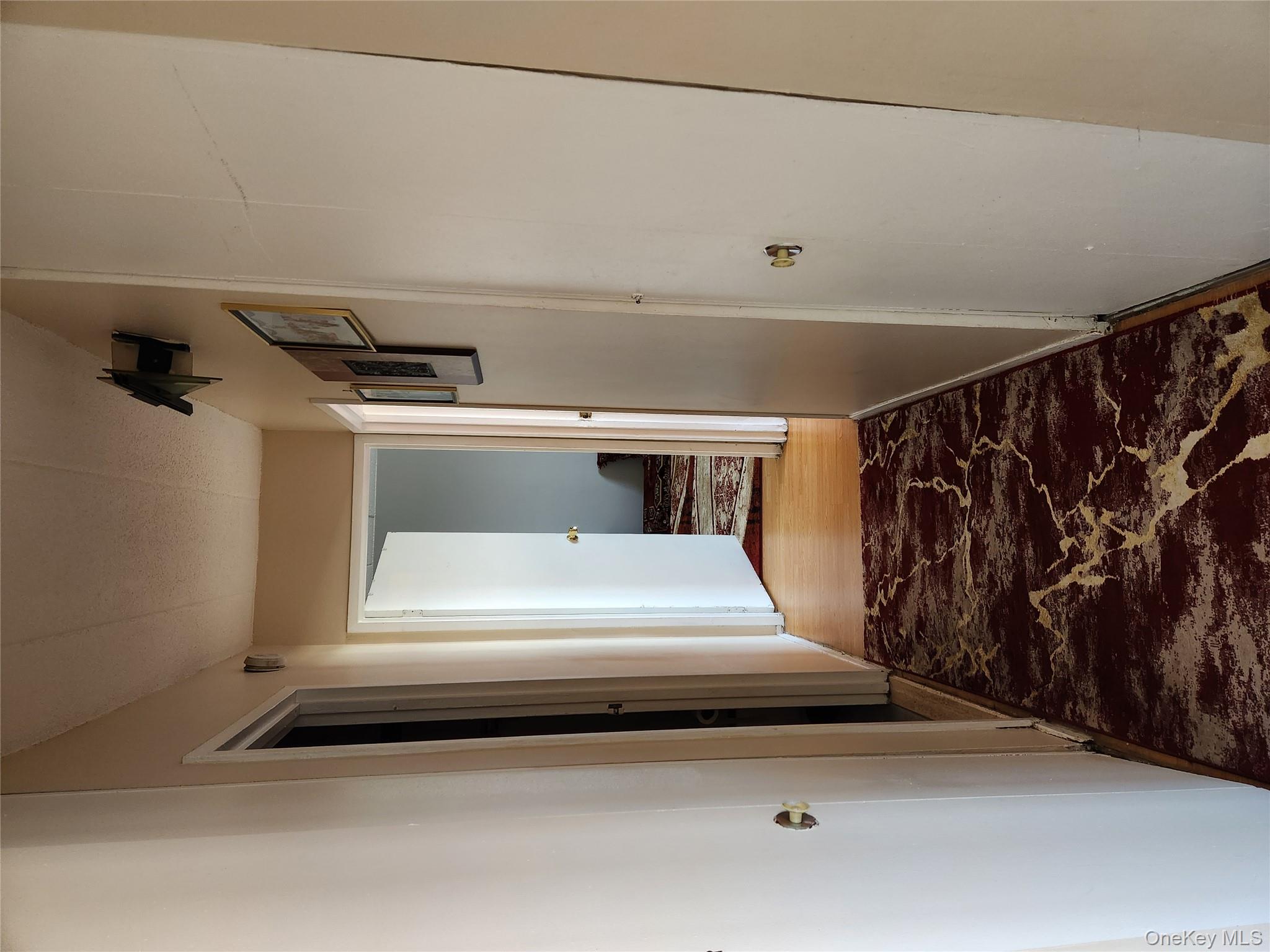 92-29 Queens Boulevard, Unit 11D Queens, NY 11374 - Photo 11 of 22 a view of a hallway view with wooden floor and a bathroom