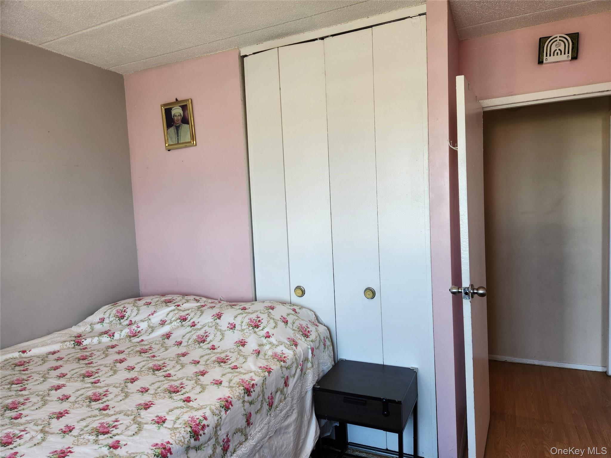 92-29 Queens Boulevard, Unit 11D Queens, NY 11374 - Photo 14 of 22 a bedroom with a bed and a chair