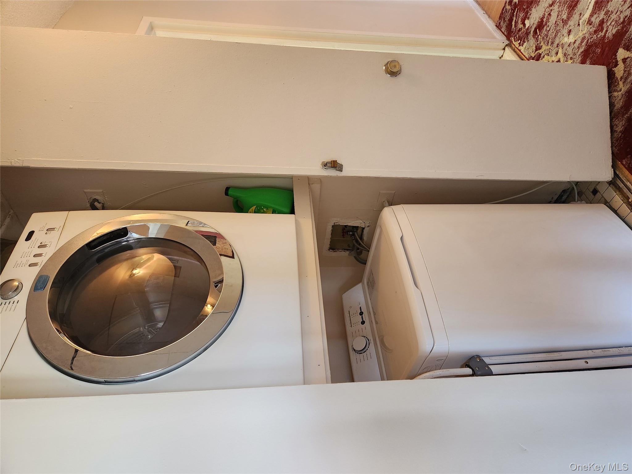 92-29 Queens Boulevard, Unit 11D Queens, NY 11374 - Photo 15 of 22 a utility room with dryer and washer