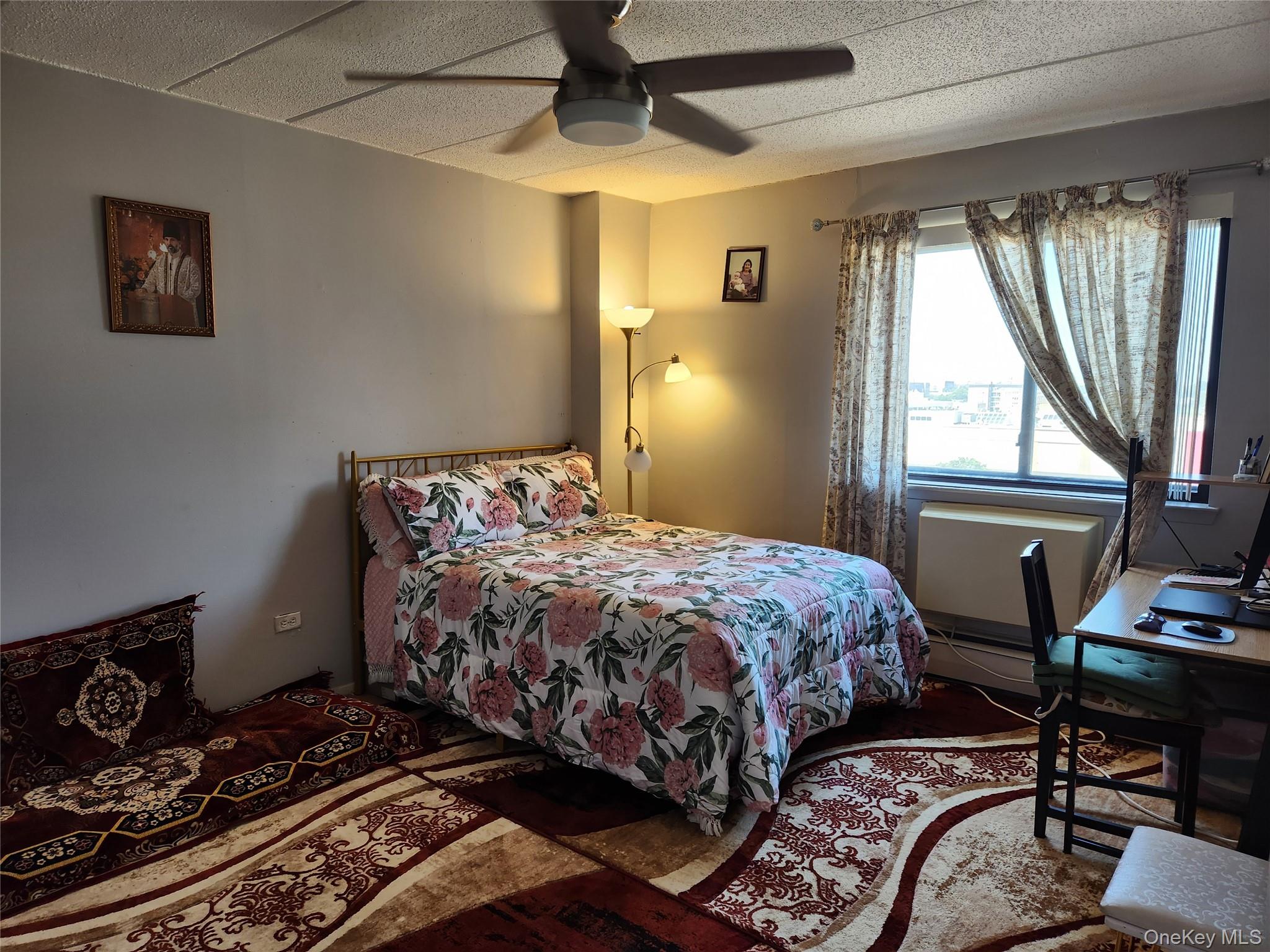 92-29 Queens Boulevard, Unit 11D Queens, NY 11374 - Photo 16 of 22 a bedroom with a bed and a window