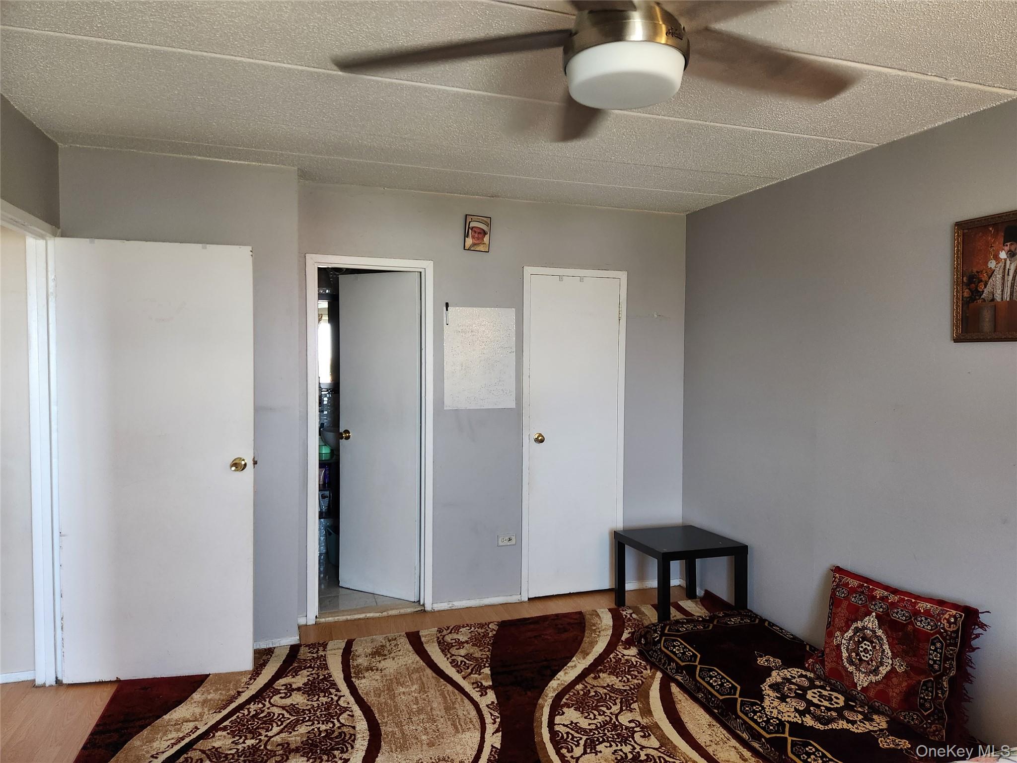 92-29 Queens Boulevard, Unit 11D Queens, NY 11374 - Photo 18 of 22 a bedroom with a bed and a chandelier