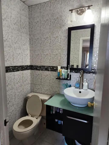 a bathroom with a toilet a sink and mirror