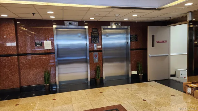 a kitchen with stainless steel appliances kitchen island a refrigerator sink and cabinets