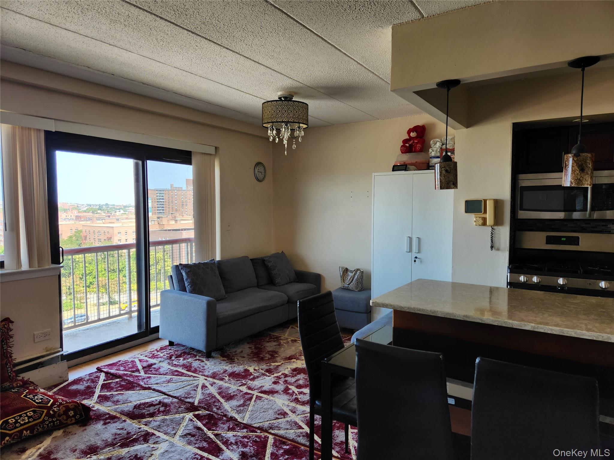 92-29 Queens Boulevard, Unit 11D Queens, NY 11374 - Photo 6 of 22 a living room with furniture and a flat screen tv