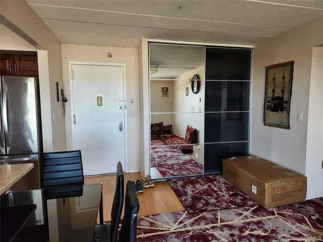 a living room with a rug and wooden floor