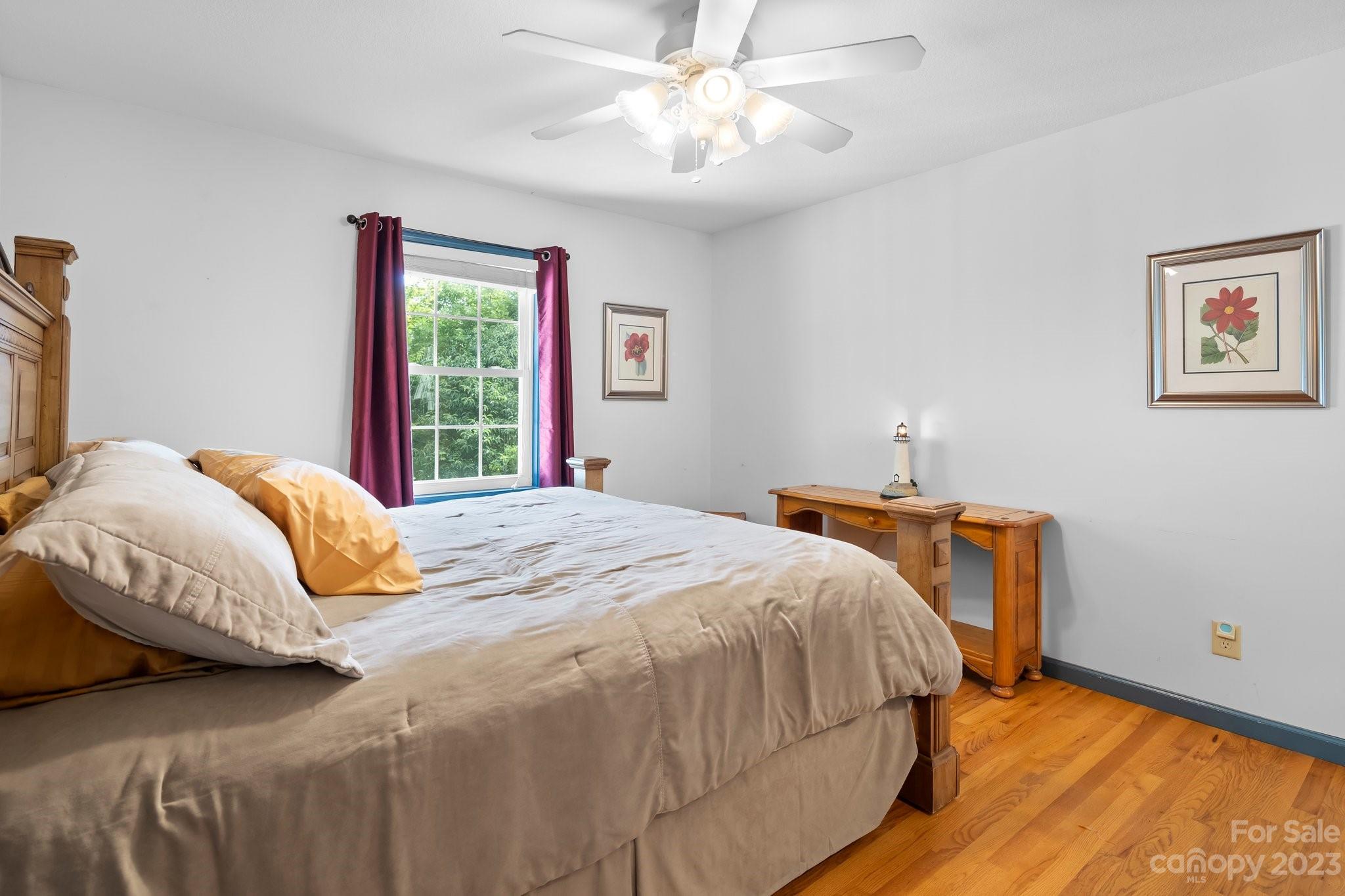 40 Autumn View Drive Hendersonville, NC 28792 - Photo 18 of 48 a bedroom with a bed and a chandelier
