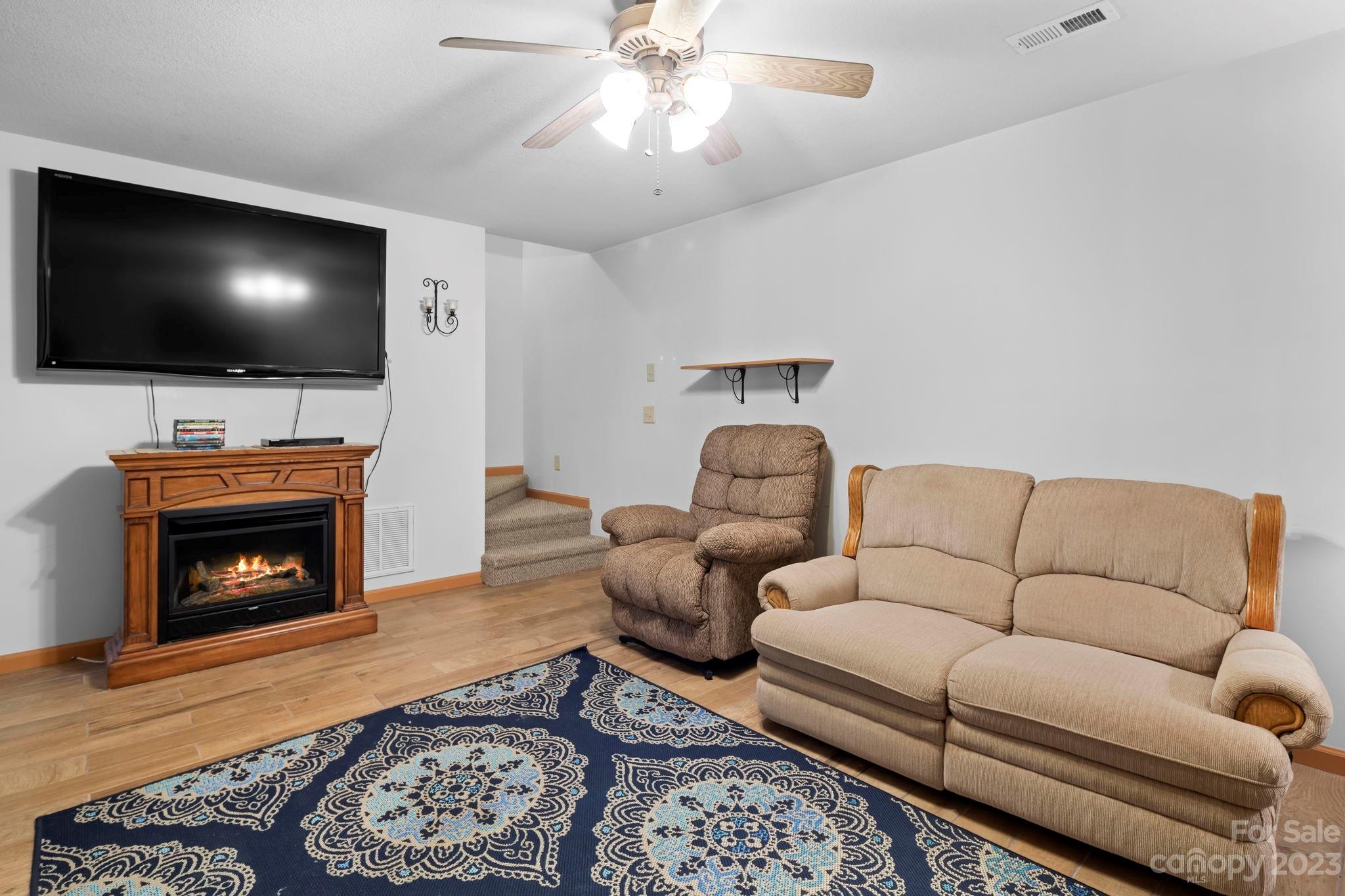 40 Autumn View Drive Hendersonville, NC 28792 - Photo 23 of 48 a living room with furniture a flat screen tv and a fireplace