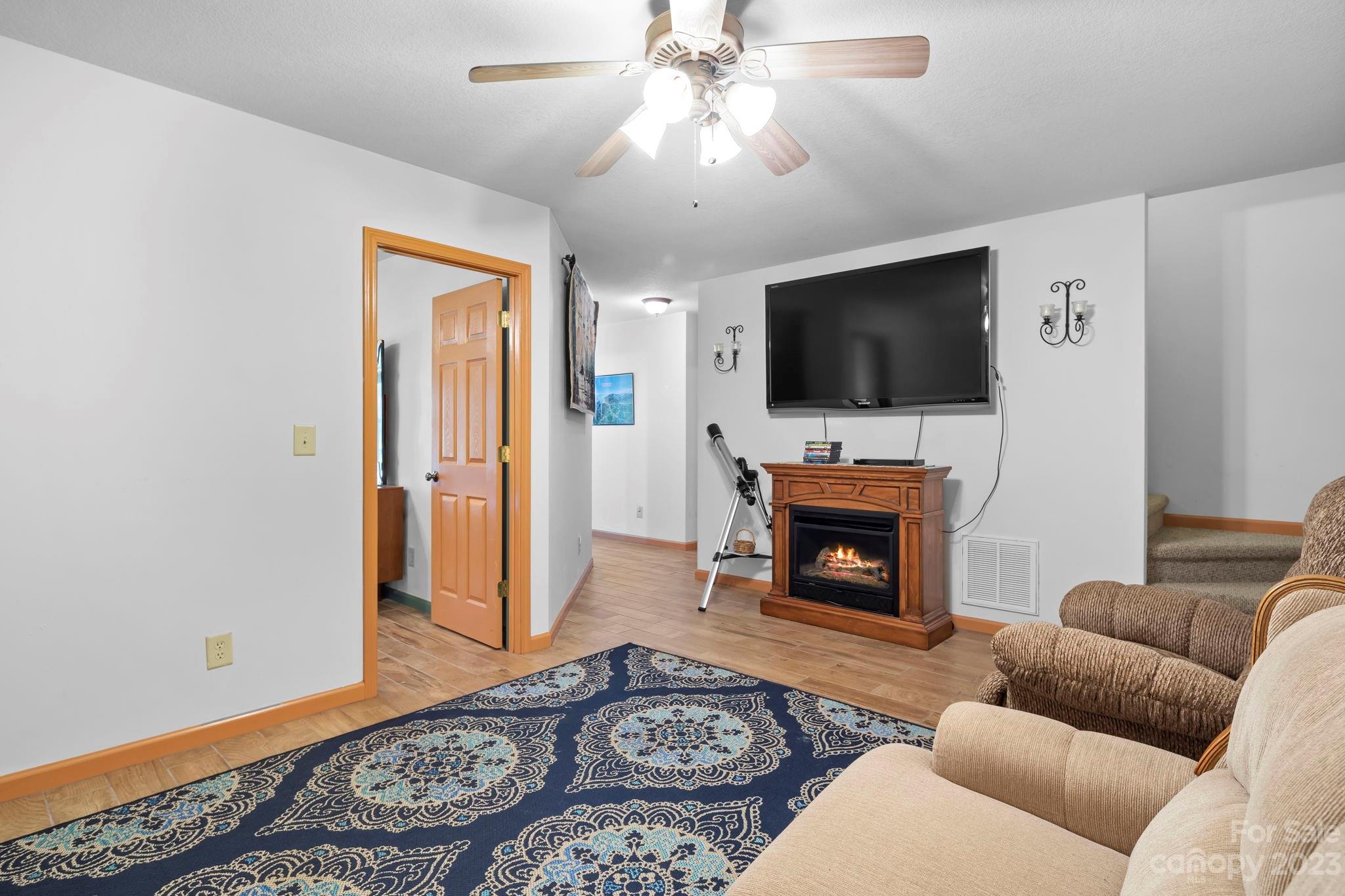 40 Autumn View Drive Hendersonville, NC 28792 - Photo 24 of 48 a living room with furniture a fireplace and a flat screen tv