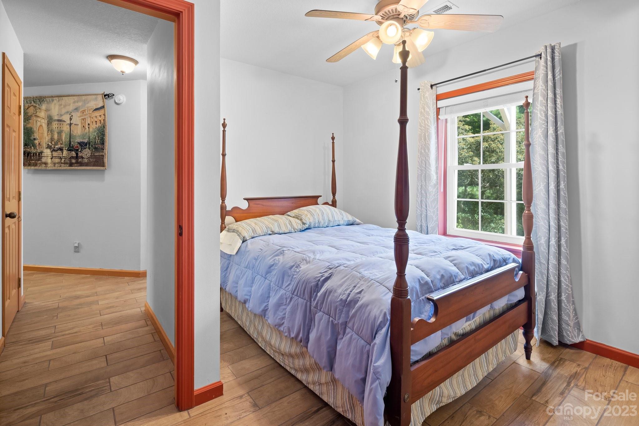 40 Autumn View Drive Hendersonville, NC 28792 - Photo 31 of 48 a bedroom with a bed and a chandelier