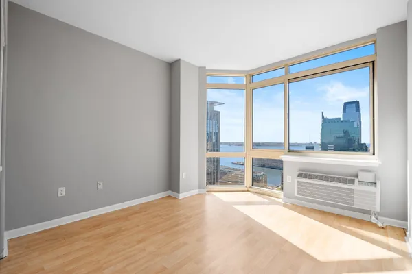 a living room with furniture window and wooden floor