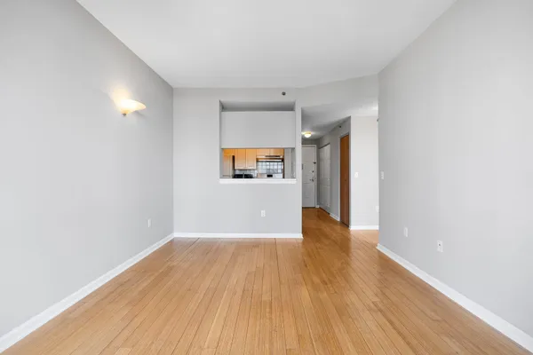 a kitchen with cabinets and wooden floor