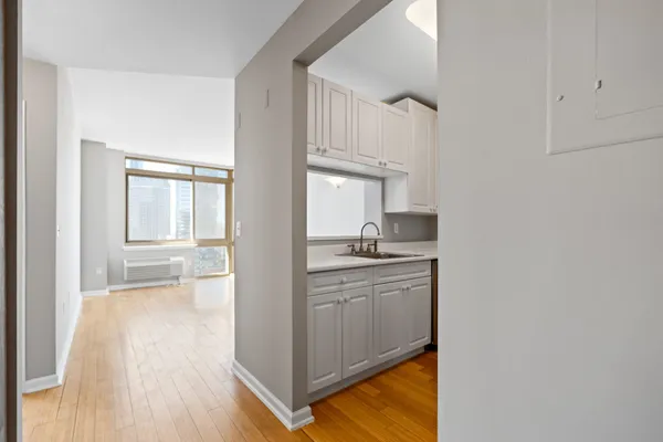 a kitchen with stainless steel appliances granite countertop a sink and dishwasher with wooden floor