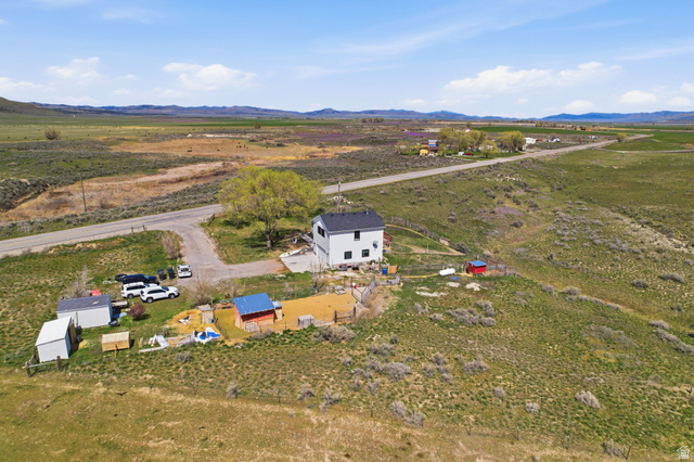 830 North Stone Road Snowville, UT 84336 - Photo 54 of 69 Aerial view of sparsely populated area with a mountain backdrop