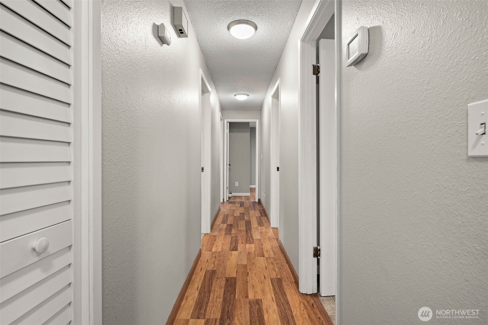 1209 Dundee Drive Cosmopolis, WA 98537 - Photo 19 of 40 a view of a hallway with wooden floor and a bathroom