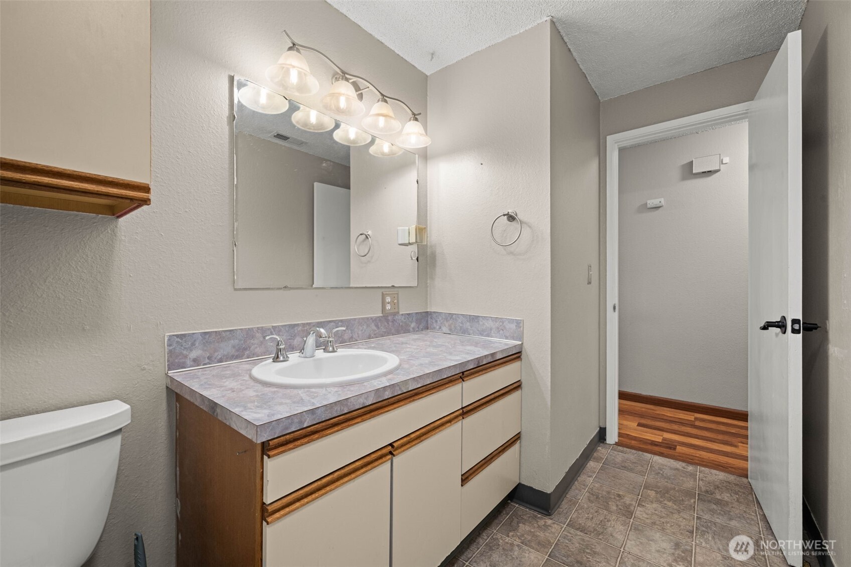 1209 Dundee Drive Cosmopolis, WA 98537 - Photo 10 of 40 a bathroom with a granite countertop sink a toilet and a mirror