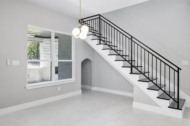 a view of staircase with lots of windows and white walls