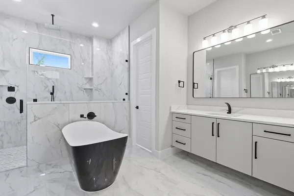 a spacious bathroom with a sink double vanity and a mirror