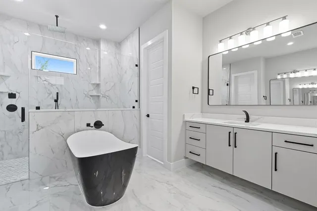 a spacious bathroom with a sink double vanity and a mirror