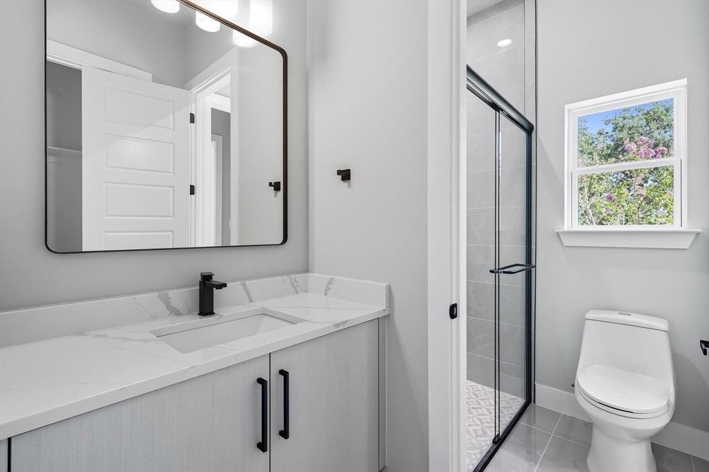 1040 Andy Ranch Azle, TX 76020 - Photo 25 of 33 a bathroom with a toilet sink and mirror