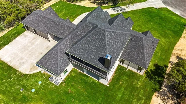 an aerial view of a house with a yard