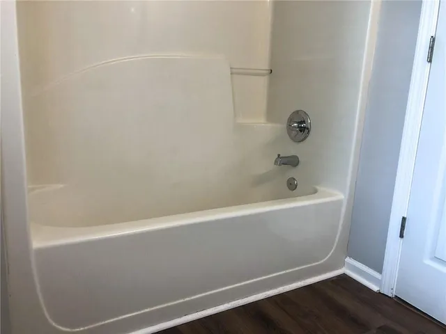 a view of a yard with plants and trees