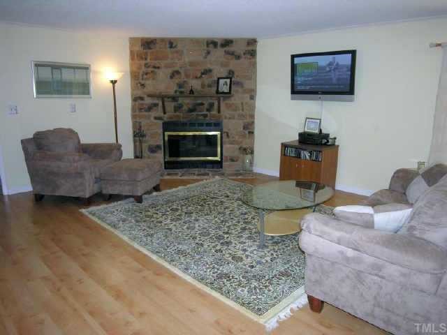 8900 Brandon Station Road Raleigh, NC 27613 - Photo 2 of 10 a living room with furniture and a fireplace