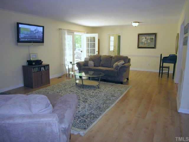 8900 Brandon Station Road Raleigh, NC 27613 - Photo 3 of 10 a living room with furniture and a flat screen tv