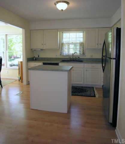 8900 Brandon Station Road Raleigh, NC 27613 - Photo 4 of 10 a kitchen with stainless steel appliances granite countertop a refrigerator a stove a sink and a microwave