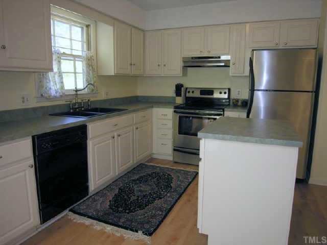8900 Brandon Station Road Raleigh, NC 27613 - Photo 5 of 10 a kitchen with a refrigerator and a stove