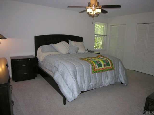 8900 Brandon Station Road Raleigh, NC 27613 - Photo 6 of 10 a bedroom with a bed and a window