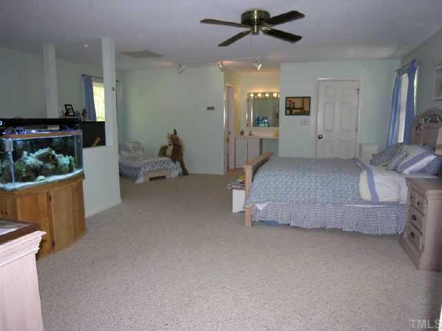 8900 Brandon Station Road Raleigh, NC 27613 - Photo 7 of 10 a bedroom with a bed and a couch